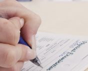 Doctor documenting in folder