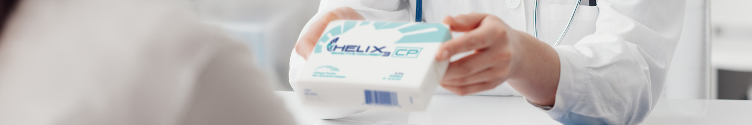 Doctor handing box of HELIX3 collagen to patient