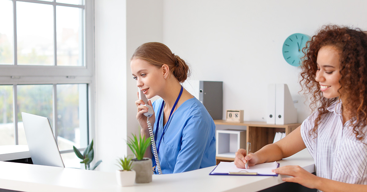 Medical receptionist and nurse at the front desk of a doctor office